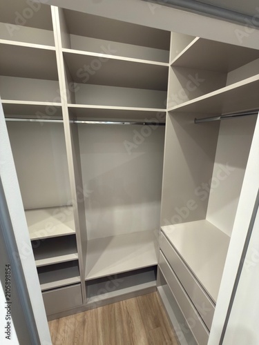 Modern Walk In Closet with Built In Shelving and Storage Drawers