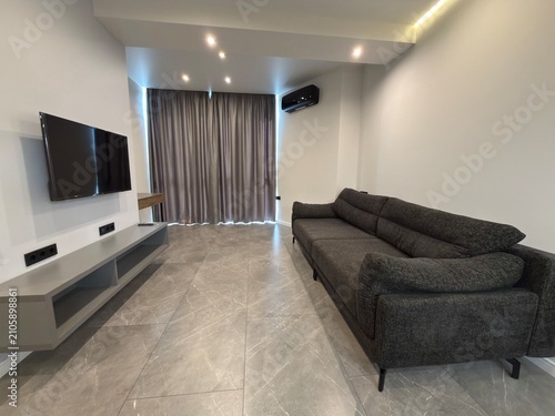 Modern Living Room Interior with Gray Sofa Wall Mounted TV and Large Curtains