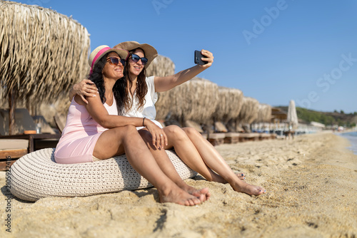 Friends taking beach selfie on summer holiday