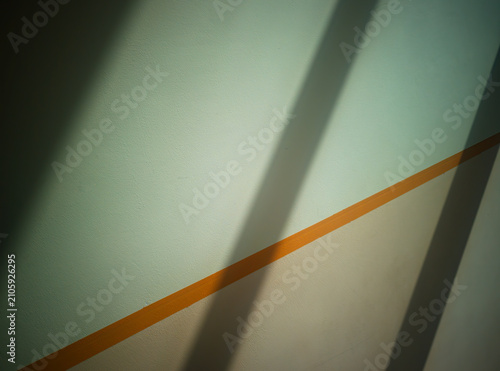 Dramatic diagonal beams of light on the office wall background