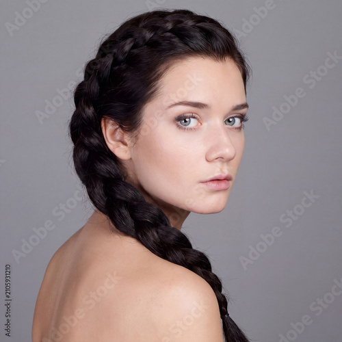 Beauty portrait of young beautiful brunette woman with bare shoulders