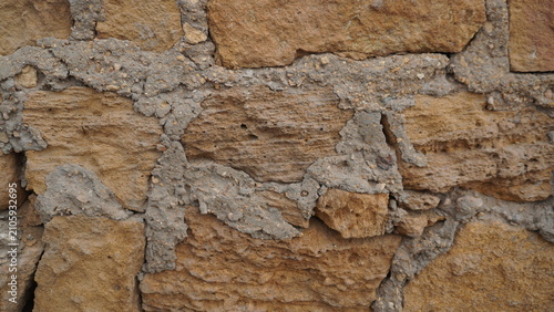 Rough stone wall texture with cement mortar, rustic architectural background for building design , industry concept