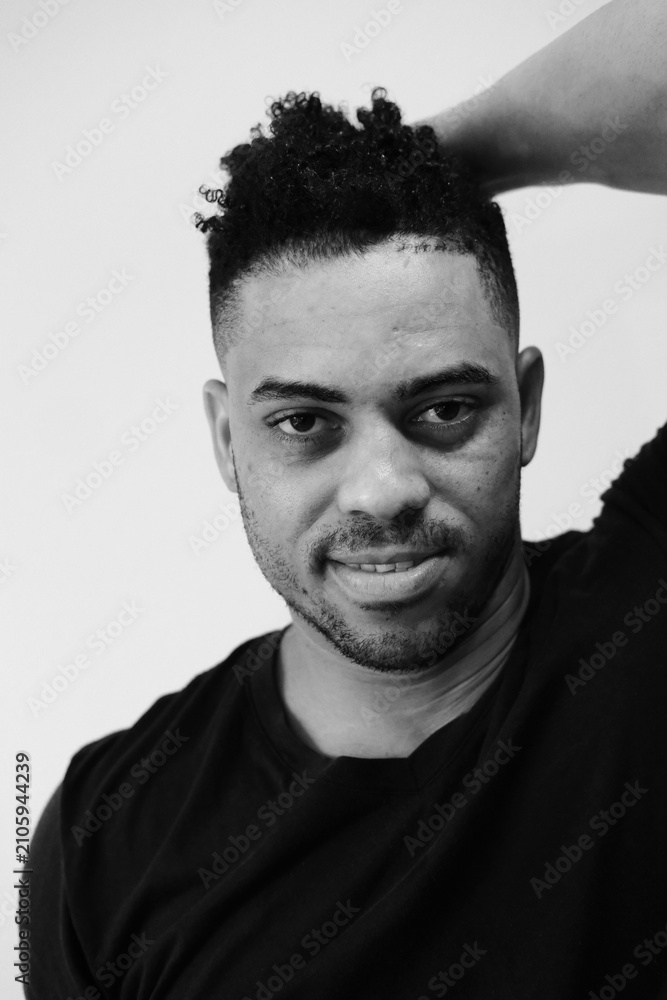 Fototapeta premium Black and white portrat of a man against white wall background. Emotions