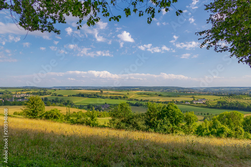 Fotografia Summer landscape, The terrain of hilly countryside, A hamlet on hillside with gr