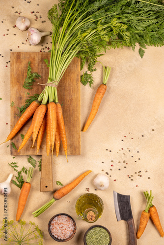Фотография Fresh carrots and spices lay on chopping board