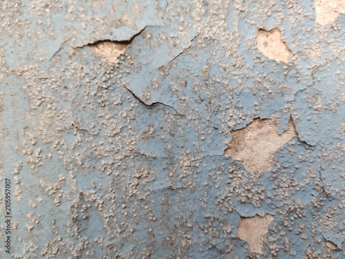 A distressed wooden surface featuring random peeling paint, chipped layers, cracks, scratches, and naturally weathered wood grain. The irregular worn texture creates a rustic, vintage, and aged appear