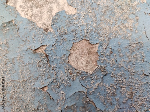 A distressed wooden surface featuring random peeling paint, chipped layers, cracks, scratches, and naturally weathered wood grain. The irregular worn texture creates a rustic, vintage, and aged appear