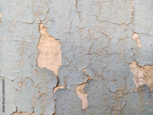 A distressed wooden surface featuring random peeling paint, chipped layers, cracks, scratches, and naturally weathered wood grain. The irregular worn texture creates a rustic, vintage, and aged appear