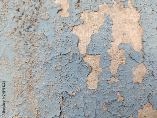 A distressed wooden surface featuring random peeling paint, chipped layers, cracks, scratches, and naturally weathered wood grain. The irregular worn texture creates a rustic, vintage, and aged appear