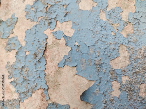 A distressed wooden surface featuring random peeling paint, chipped layers, cracks, scratches, and naturally weathered wood grain. The irregular worn texture creates a rustic, vintage, and aged appear