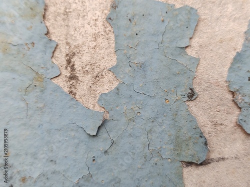 A distressed wooden surface featuring random peeling paint, chipped layers, cracks, scratches, and naturally weathered wood grain. The irregular worn texture creates a rustic, vintage, and aged appear