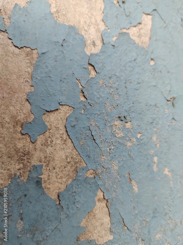 A distressed wooden surface featuring random peeling paint, chipped layers, cracks, scratches, and naturally weathered wood grain. The irregular worn texture creates a rustic, vintage, and aged appear