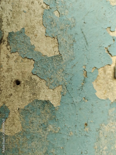 A distressed wooden surface featuring random peeling paint, chipped layers, cracks, scratches, and naturally weathered wood grain. The irregular worn texture creates a rustic, vintage, and aged appear