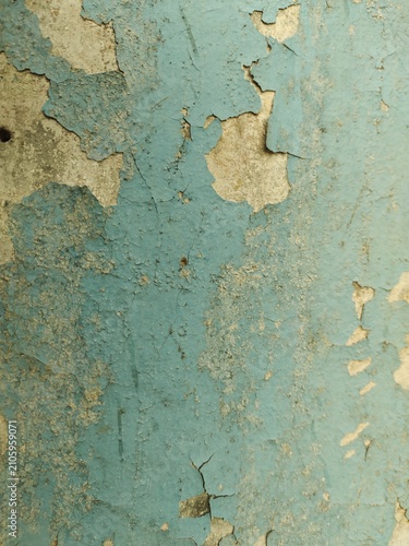 A distressed wooden surface featuring random peeling paint, chipped layers, cracks, scratches, and naturally weathered wood grain. The irregular worn texture creates a rustic, vintage, and aged appear