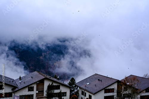 Wengen, Switzerland - 11.03.2026. An atmospheric, high-angle view of alpine chalets in the car-free village of Wengen, situated in the Bernese Oberland region of Switzerland. Traditional dark-roofed h