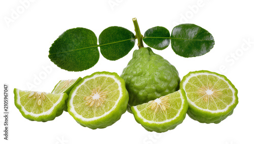 Canvas Print Isolated green kaffir lime fruit and fragrant leaves, whole and cut, fresh citru