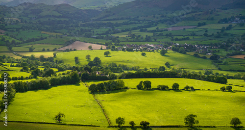 An aerial perspective of the lush green pastures and winding lanes looking towards Llansilin near Oswestry on the border of Shropshire and Wales.