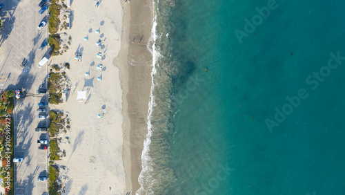 Bild auf Leinwand Aerial Top Down View of Sandy Beach and Turquoise Ocean Waves in Santa Barbara,