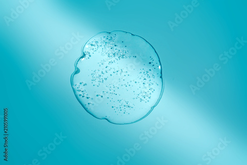 Blue cosmetic gel texture with bubbles on surface