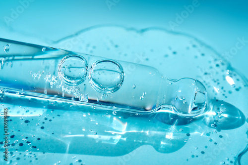 Cosmetic serum pipette extracting moisturizing liquid droplets