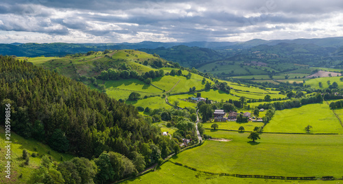 An aerial perspective of the lush green pastures and winding lanes looking towards Llansilin near Oswestry on the border of Shropshire and Wales.