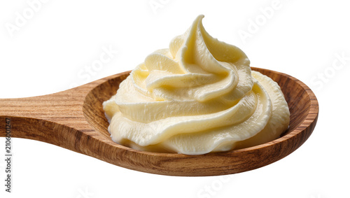 Obraz na płótnie Isolated dollop of creamy mayonnaise or delicious sauce in a wooden spoon ready