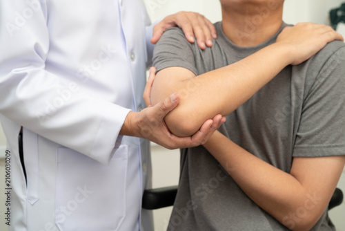Physical therapy, Asian therapist doctor treat perform pain young man in hospital.