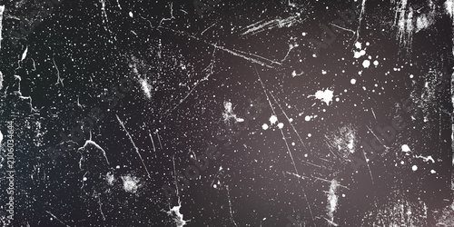 Grunge texture with white paint splatters and scratches on a dark distressed surface
