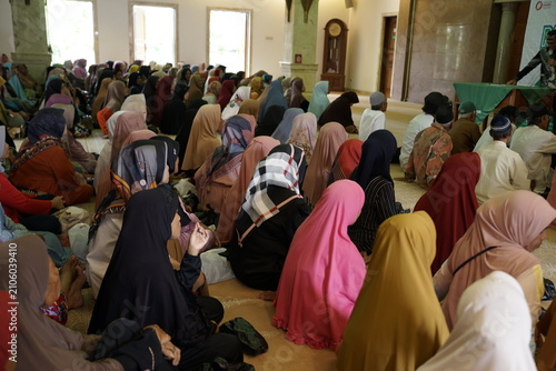 Bild auf Leinwand Diverse group of Muslim women gathered for prayer in a mosque.