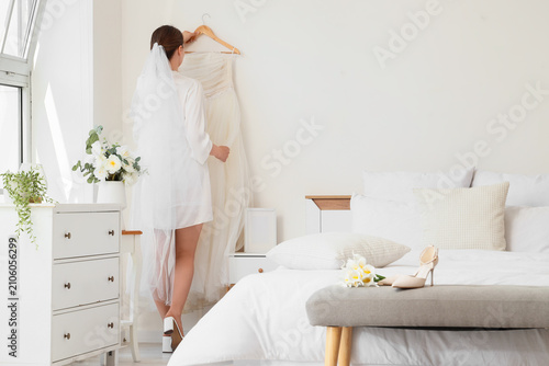 Bride in white robe and vei...