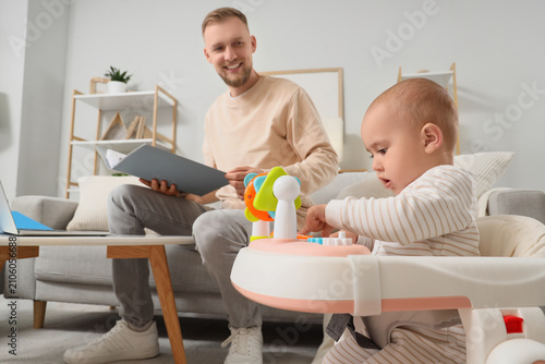 Happy father working from h...