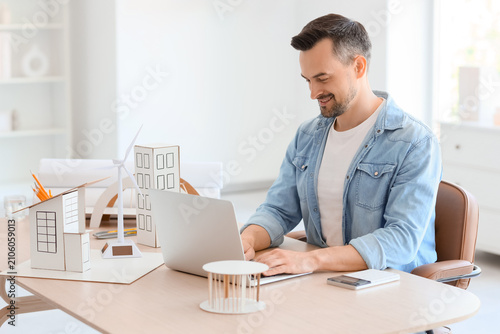 Male architect working with...