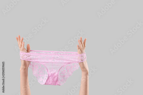 Woman holding pink lace pan...