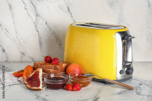 Yellow toaster with bread s...