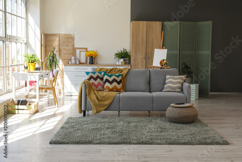 Comfortable sofa with plaid...