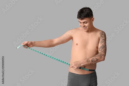Young man with measuring ta...