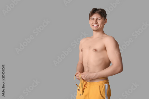 Sporty young man measuring ...