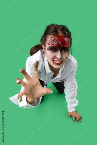 Scary zombie woman on green...