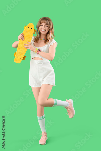 Young woman with skateboard...