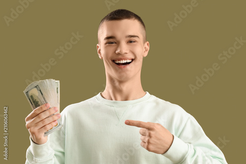 Young man pointing at dolla...