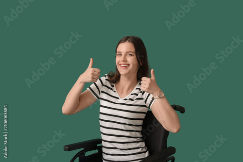 Young woman showing thumbs-...