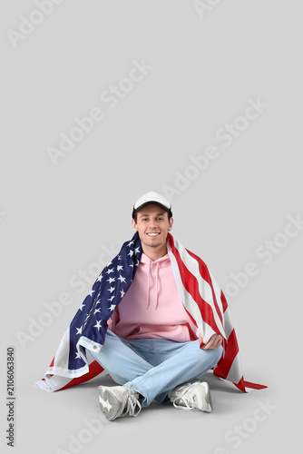 Young man with USA flag sit...
