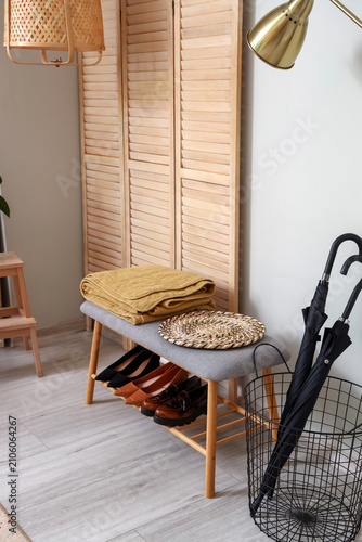 Bench with shoes, umbrellas...
