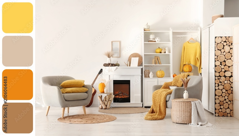 Obraz premium Cozy autumn living room interior with fireplace, armchairs, Pumpkins, and a warm color palette