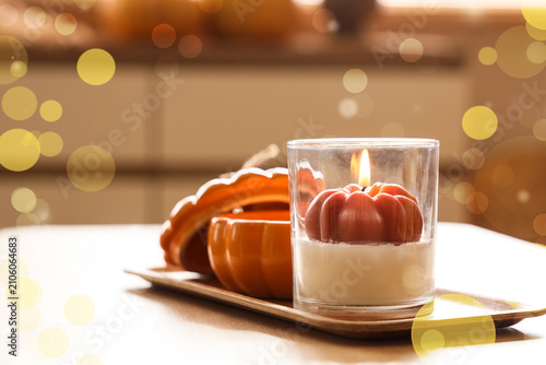 Pumpkin shaped candle in a ...