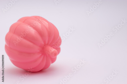 Pink lipstick with daisy flower on pastel background
