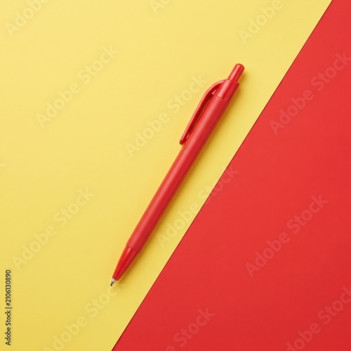 Minimalist Flat Lay of Red Ballpoint Pen on Vibrant Yellow and Red Diagonal Background, Professional Stationery for Office Design with Copy Space and Flexible Layout