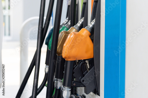 Foto Gas station nozzles ready for refueling in bright daylight