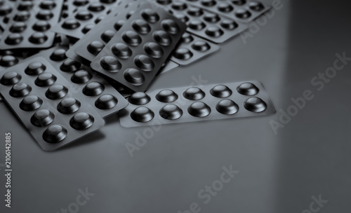 Foto Silver aluminum blister packs with copy space on gray background for pharmaceutical industry