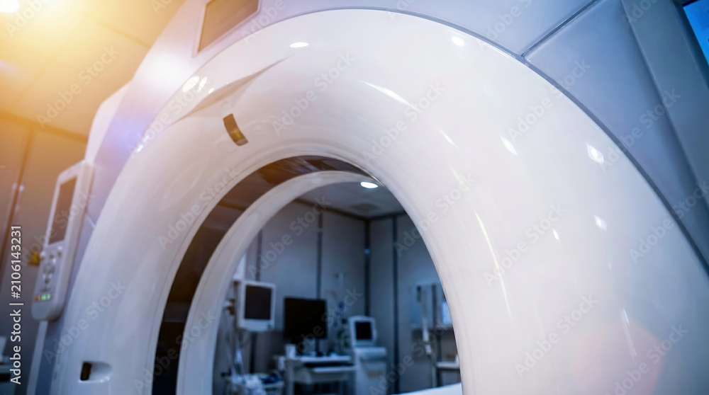 Fototapeta premium CT scanner machine showing circular gantry opening in modern hospital radiology room, medical imaging technology and diagnostic healthcare concept.